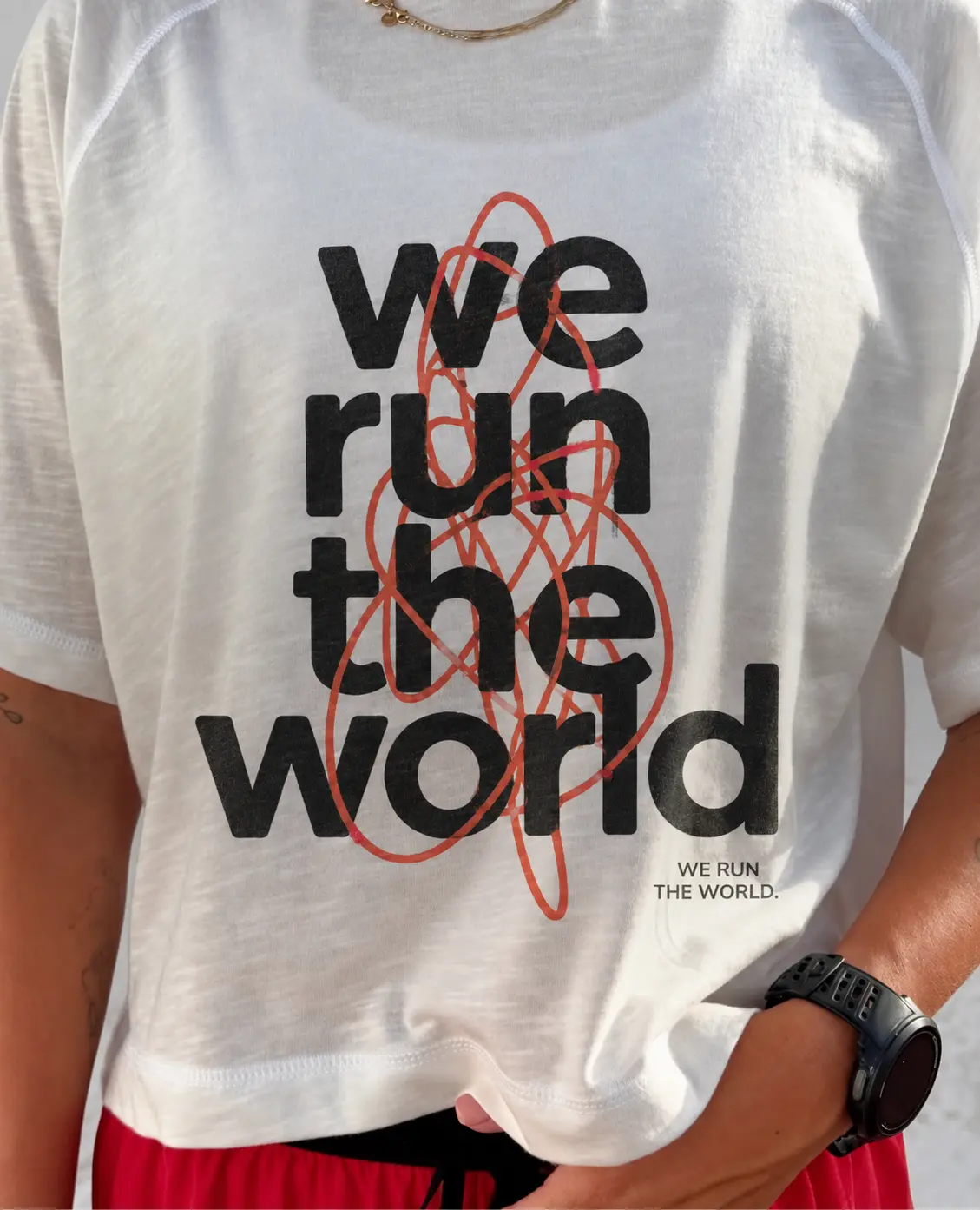 Close view of the white We Run the World tee print